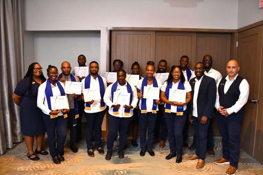 Ghislain Boutoulle, hotel manager at Beaches Turks and Caicos (right) beams as he congratulates bar department team member, Andrew Clarke on his successful course completion.
