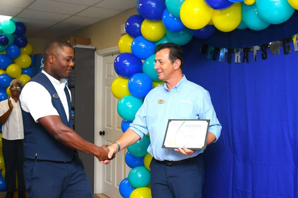 A group of proud team members from Sandals South Coast team pose for a quick photo op after receiving their training completion certificates.